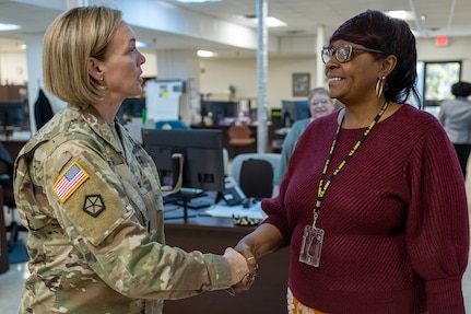 Col. Michelle M. Williams, U.S. Army Financial Management Command commander, presents a commander’s challenge coin to Sharon Pettaway, USAFMCOM Fort Knox Army Military Pay Office deputy chief, at Fort Knox, Ky., March 4, 2026. USAFMCOM’s leadership visited the Fort Knox AMPO during a major subordinate command update to the U.S. Army Materiel Command and thanked the employees for their hard work in supporting Soldiers and their families. (U.S. Army photo by Mark R. W. Orders-Woempner)
