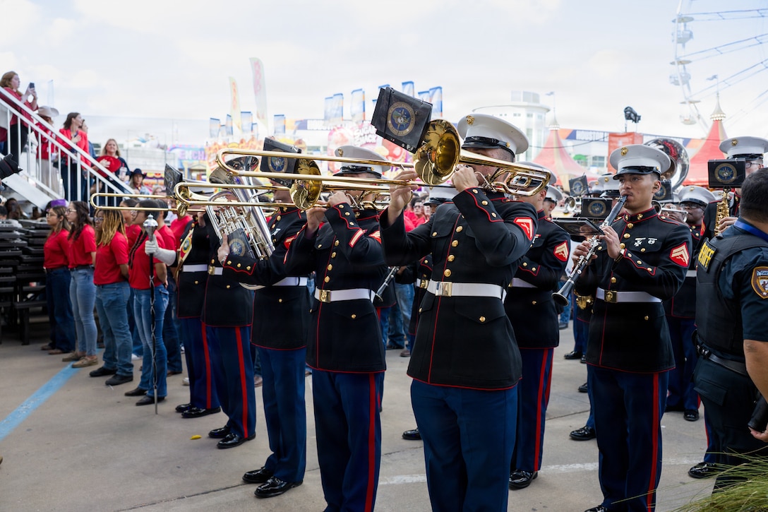 The U.S. Marine Forces Reserve Band performs at the Houston Livestock Show and Rodeo Armed Forces Appreciation Day prior to conducting an enlistment ceremony in Houston, March 4, 2026. Armed Forces Appreciation Day honored nearly 4,000 military personnel and veterans, including a joint service enlistment ceremony for approximately 500 recruits. (U.S. Marine Corps photo by SSgt. Ethan M. LeBlanc)