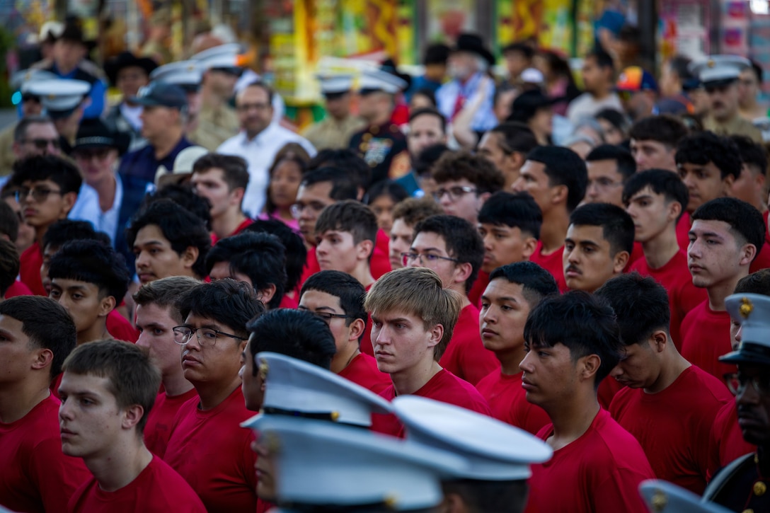 U.S. Marine Corps poolees from across the state of Texas stand by to participate in an enlistment ceremony at the Houston Livestock Show and Rodeo Armed Forces Appreciation Day in Houston, March 4, 2026. Armed Forces Appreciation Day honored nearly 4,000 military personnel and veterans, including a joint service enlistment ceremony for approximately 500 recruits. (U.S. Marine Corps photo by SSgt. Ethan M. LeBlanc)