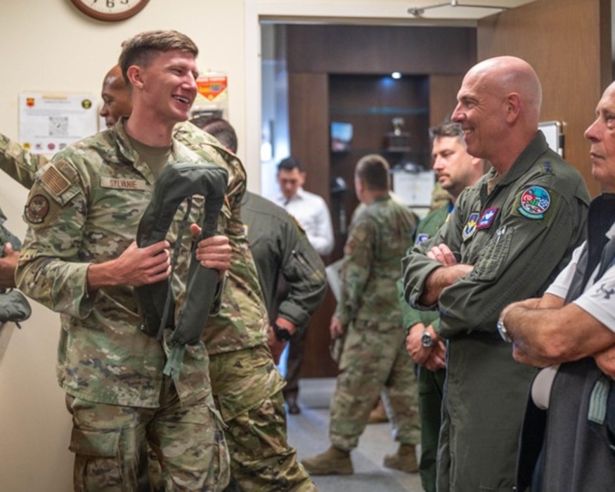 U.S. Air Force Senior Airman Kyle Sylvanie (left), 56th Operations Support Squadron aircrew flight equipment technician, discusses mission capabilities with Lt. Gen. Clark Quinn, commander of Air Education and Training Command, Feb. 26, 2026, at Luke Air Force Base, Arizona. Airmen assigned to the 56th Fighter Wing demonstrated how operations and maintenance teams integrate to generate combat-ready Airmen and deliver combat capability for the USAF. During the visit, Airmen from the 62nd Fighter Squadron and 62nd Aircraft Maintenance Unit highlighted the precision, coordination, and expertise required to sustain mission readiness.