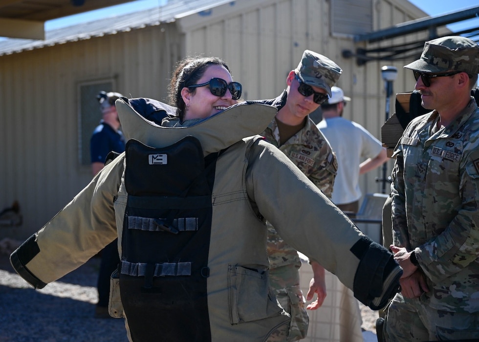 A civic leader participating in a nationwide civic leader tour dons an Explosive Ordinance Disposal bomb suit during a capabilities demonstration at Barry M. Goldwater Range, Arizona. The visit provided community leaders a firsthand look at how Luke Air Force Base trains the world’s greatest fighter pilots and combat-ready Airmen in support of Air Education and Training Command’s mission.