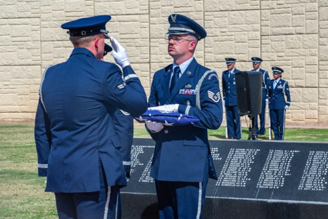 U.S. Air Force Staff Sgt. Dalton Moore, 56th Force Support Squadron assistant non-commissioned officer in charge of honor guard, and Airman 1st Class Trevor Smart, 56th Force Support Squadron ceremonial guardsman, perform a demonstration of a flag presentation, Feb. 26, 2026, at Luke Air Force Base, Arizona. The primary mission of the honor guard is to military honors in tribute to the nation’s fallen service members. The honor guard showcased the precision and professionalism of Airmen during a visit by Air Education Training Command leadership and civic leaders.