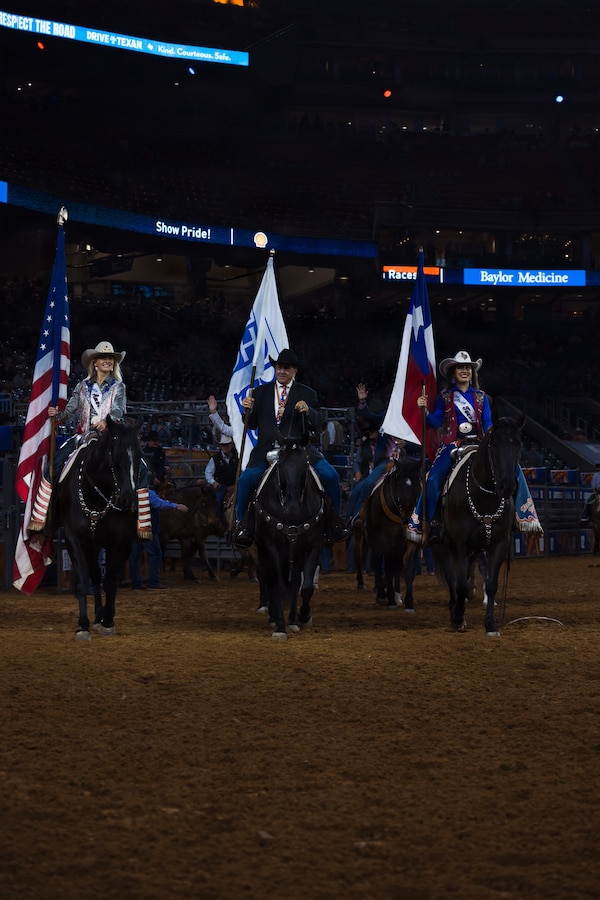 Houston Livestock Show and Rodeo staff ride into the main rodeo arena during the Grand Entry on Armed Forces Appreciation Day in Houston, March 4, 2026. Armed Forces Appreciation Day honored nearly 4,000 military personnel and veterans, including a joint service enlistment ceremony for approximately 500 recruits. (U.S. Marine Corps photo by SSgt. Ethan M. LeBlanc)