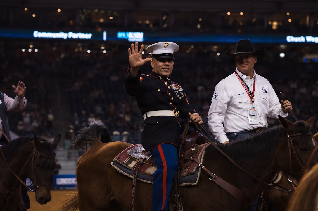 U.S. Marine Corps Sgt. Maj. Edwin A. Mota, command senior enlisted leader of Marine Forces Reserve and Marine Forces South, waves to the crowd in the main rodeo arena during the Houston Livestock Show and Rodeo Grand Entry on Armed Forces Appreciation Day in Houston, March 4, 2026. The Armed Forces Appreciation Day is a display of community support for the military, the participation of the commander and senior enlisted leader in the Grand Entry underscores the significance of this day and the city's deep gratitude for the dedication of America's troops. (U.S. Marine Corps photo by SSgt. Ethan M. LeBlanc)