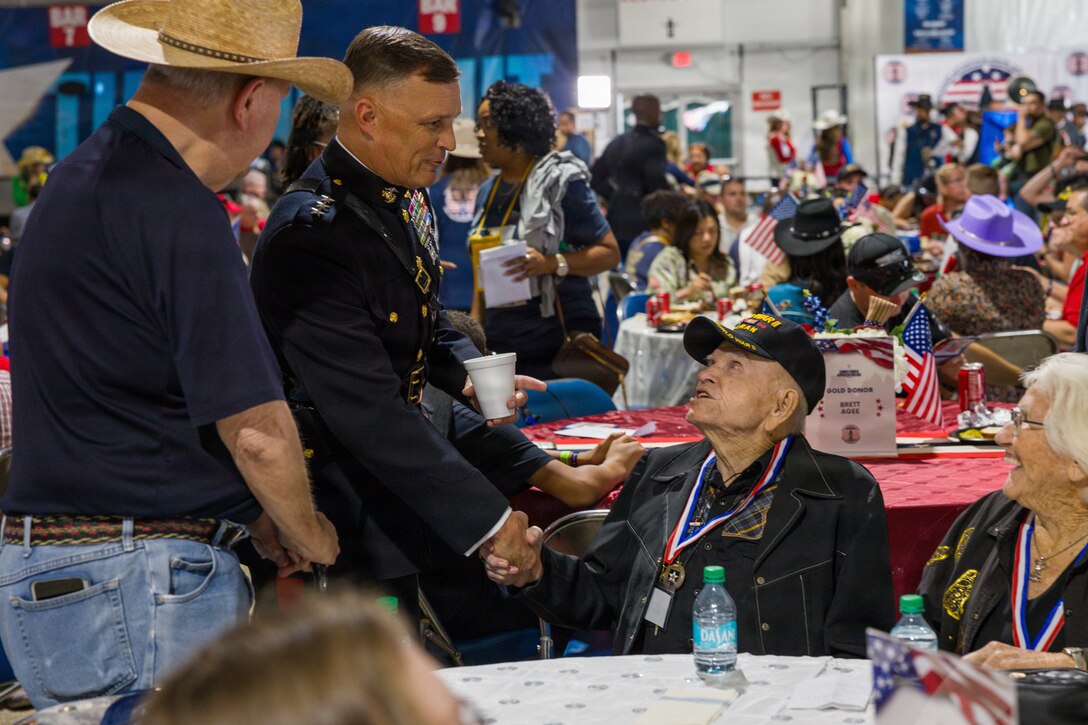 U.S. Marine Corps Lt. Gen. Leonard F. Anderson IV, commander of Marine Forces Reserve and Marine Forces South, talks with U.S. Army Pvt Chester “Buck” Sloan (Ret.), a WWII veteran, and U.S. Air Force veteran Shirley Sloan (Ret.), a Vietnam conflict veteran, members of the “Greatest Generation” at the Houston Livestock Show and Rodeo Armed Forces Appreciation Day in Houston, March 4, 2026. Armed Forces Appreciation Day honored nearly 4,000 military personnel and veterans, including a joint service enlistment ceremony for approximately 500 recruits. (U.S. Marine Corps photo by SSgt. Ethan M. LeBlanc)