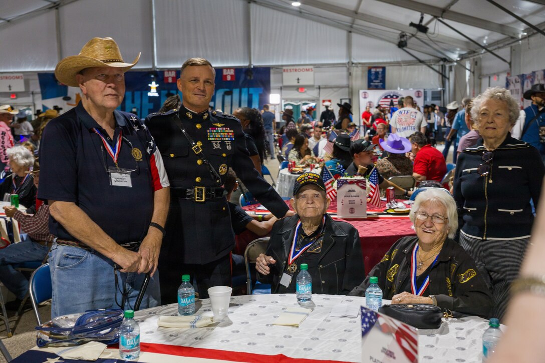 U.S. Marine Corps Lt. Gen. Leonard F. Anderson IV, commander of Marine Forces Reserve and Marine Forces South, poses for a photo with members of the “Greatest Generation” at the Houston Livestock Show and Rodeo Armed Forces Appreciation Day in Houston, March 4, 2026. Armed Forces Appreciation Day honored nearly 4,000 military personnel and veterans, including a joint service enlistment ceremony for approximately 500 recruits. (U.S. Marine Corps photo by SSgt. Ethan M. LeBlanc)