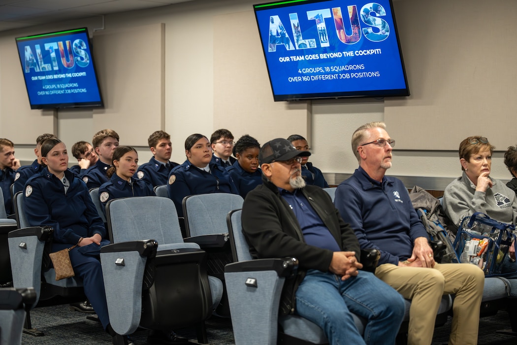 Junior Reserve Officers' Training Corps cadets from Detachment OK-20061 and local school board members listen to a briefing about a C-17 Globemaster III aircraft at Altus Air Force Base, Oklahoma, March 3, 2026. The visit concluded with an incentive flight that familiarized cadets and school board members with the C-17’s airlift mission over the local area. (U.S. Air Force photo by Airman 1st Class Nathan Langston)