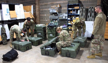 Soldiers of the 708th Medical Company Ground Ambulance check their supplies in preparation for shuttle operations in April.