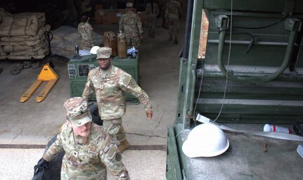 Soldiers of the 708th Medical Company Ground Ambulance load supplies into the back of a light medium tactical vehicle in preparation for shuttle operations in April.
