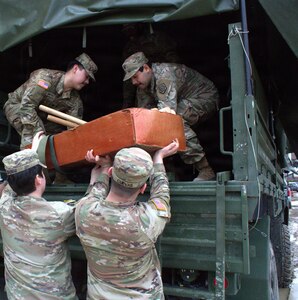 Soldiers of the 708th Medical Company Ground Ambulance load supplies into the back of a light medium tactical vehicle in preparation for shuttle operations in April.