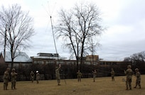 Soldiers of the 708th Medical Company Ground Ambulance lower an antenna at the conclusion of training.