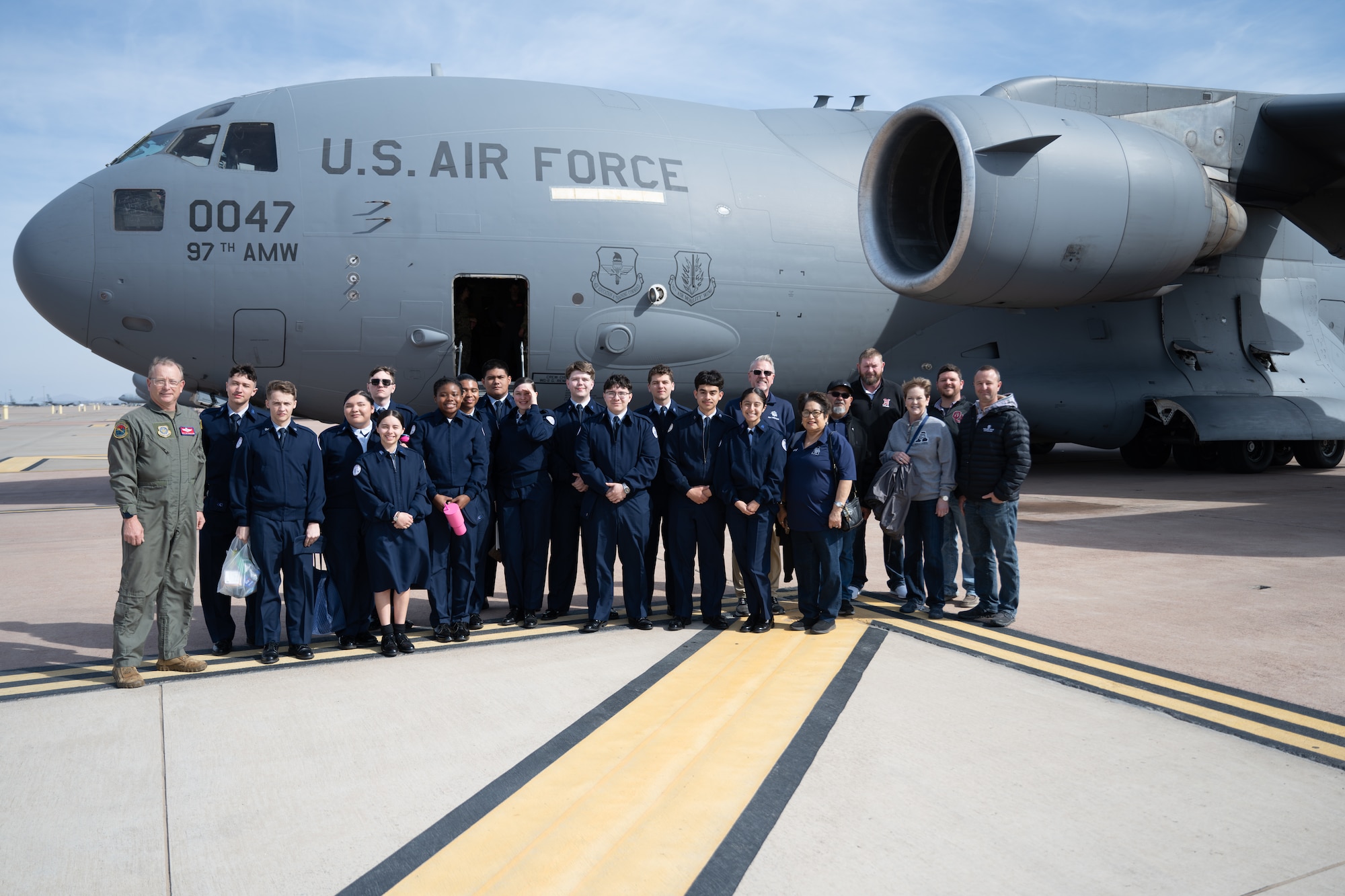 Junior Reserve Officers' Training Corps cadets from Detachment OK-20061 and local school board members pose for a group photo in front of a C-17 Globemaster III aircraft at Altus Air Force Base, Oklahoma, March 3, 2026. The C-17 is a strategic airlifter designed to deliver troops and cargo directly into austere airfields worldwide. (U.S. Air Force photo by Airman 1st Class Nathan Langston)