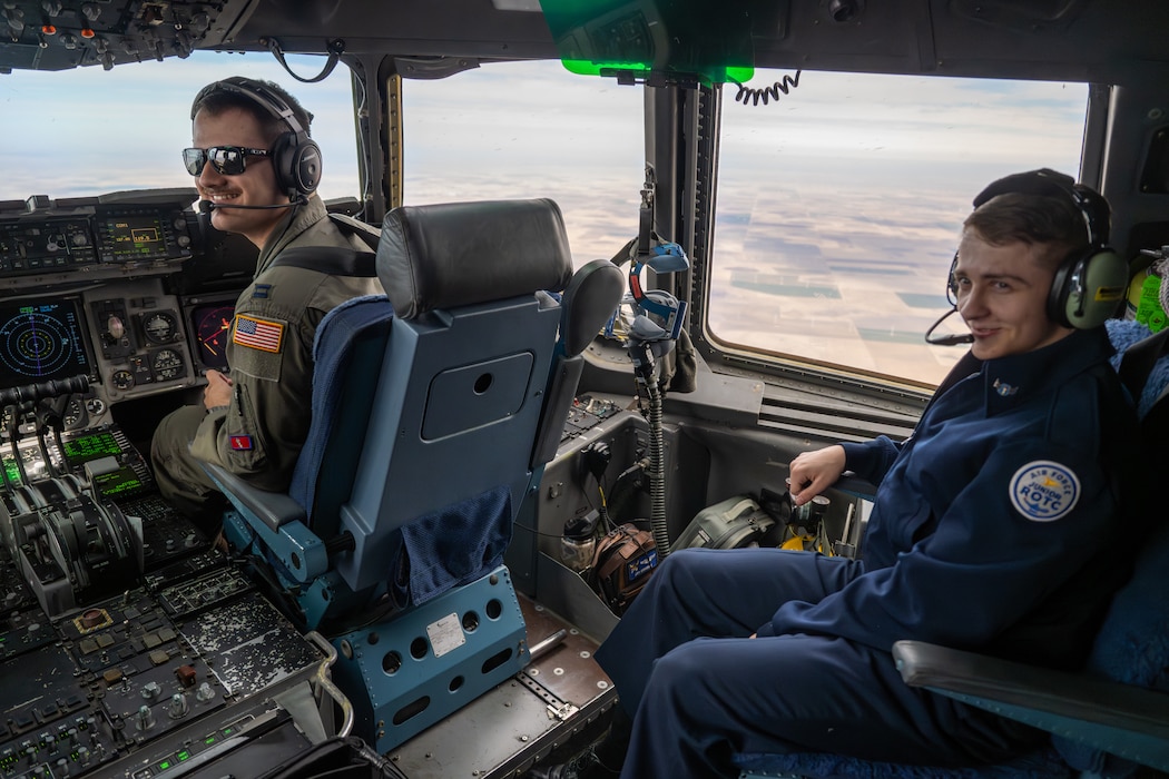 U.S. Air Force Capt. Michael Kavanagh, 58th Airlift Squadron formal training unit instructor pilot, speaks with a Junior Reserve Officers' Training Corps cadet from Detachment OK-20061 during an incentive flight over Oklahoma, March 3, 2026. The flight provided cadets an opportunity to learn about Air Force airlift operations and career paths from assigned aircrew members. (U.S. Air Force photo by Airman 1st Class Nathan Langston)