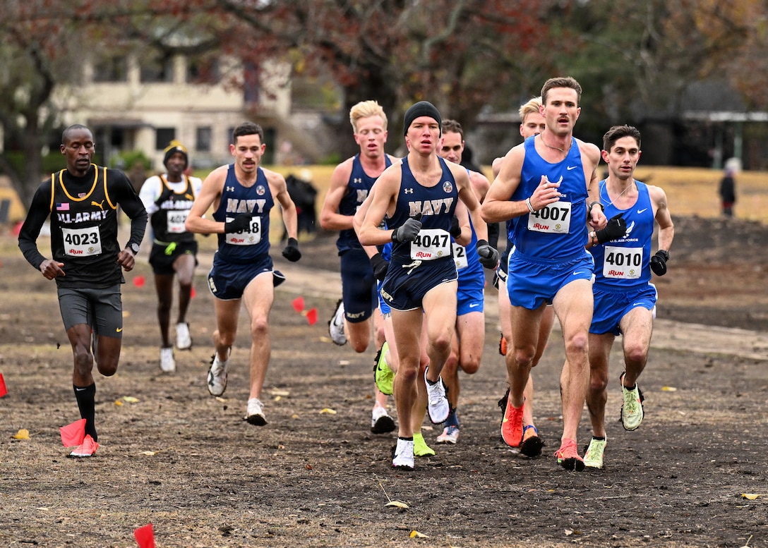 Navy Ensign Murphy Smith (center) leads the pack. Service members compete during the Armed Forces Sports Cross Country Championships at Windcrest Golf Club in Windcrest, Texas, Jan. 24, 2026. The top finishers earn selection to represent the United States at the International Military Sports Council (CISM) World Winter Games in Trikala, Greece, scheduled for Feb. 25 through March 2, 2026.