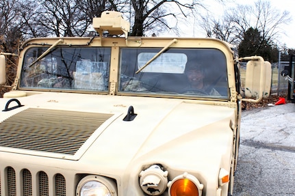 Soldiers with the 108th Multifunctional Medical Battalion drive a High Mobility Multipurpose Wheeled Vehicle as part of the Forest Park St. Patrick's Day parade in Forest Park, Ill.