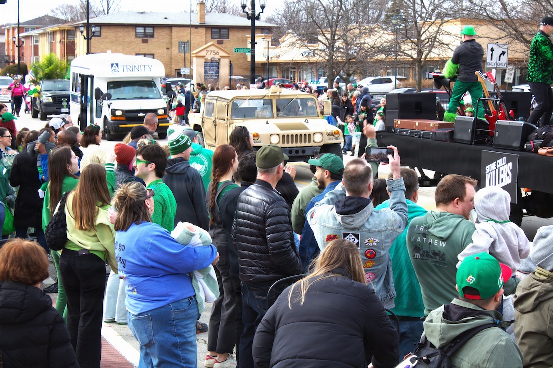Soldiers with the 108th Multifunctional Medical Battalion drive a High Mobility Multipurpose Wheeled Vehicle as part of the Forest Park St. Patrick's Day parade in Forest Park, Ill.