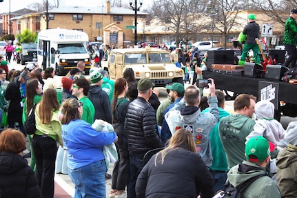 Soldiers with the 108th Multifunctional Medical Battalion drive a High Mobility Multipurpose Wheeled Vehicle as part of the Forest Park St. Patrick's Day parade in Forest Park, Ill.