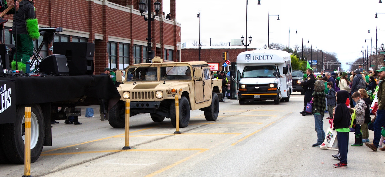 Soldiers with the 108th Multifunctional Medical Battalion drive a High Mobility Multipurpose Wheeled Vehicle as part of the Forest Park St. Patrick's Day parade in Forest Park, Ill.
