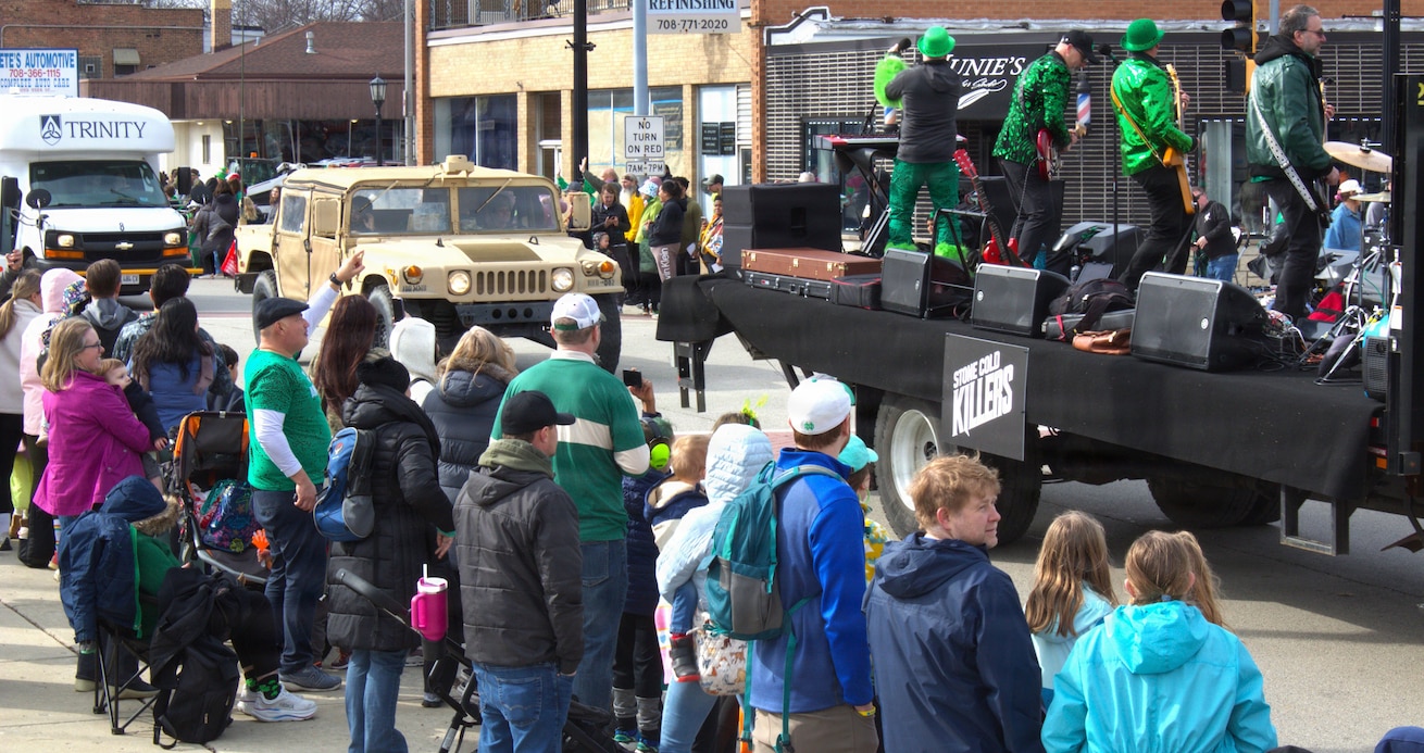 Soldiers with the 108th Multifunctional Medical Battalion drive a High Mobility Multipurpose Wheeled Vehicle as part of the Forest Park St. Patrick's Day parade in Forest Park, Ill.