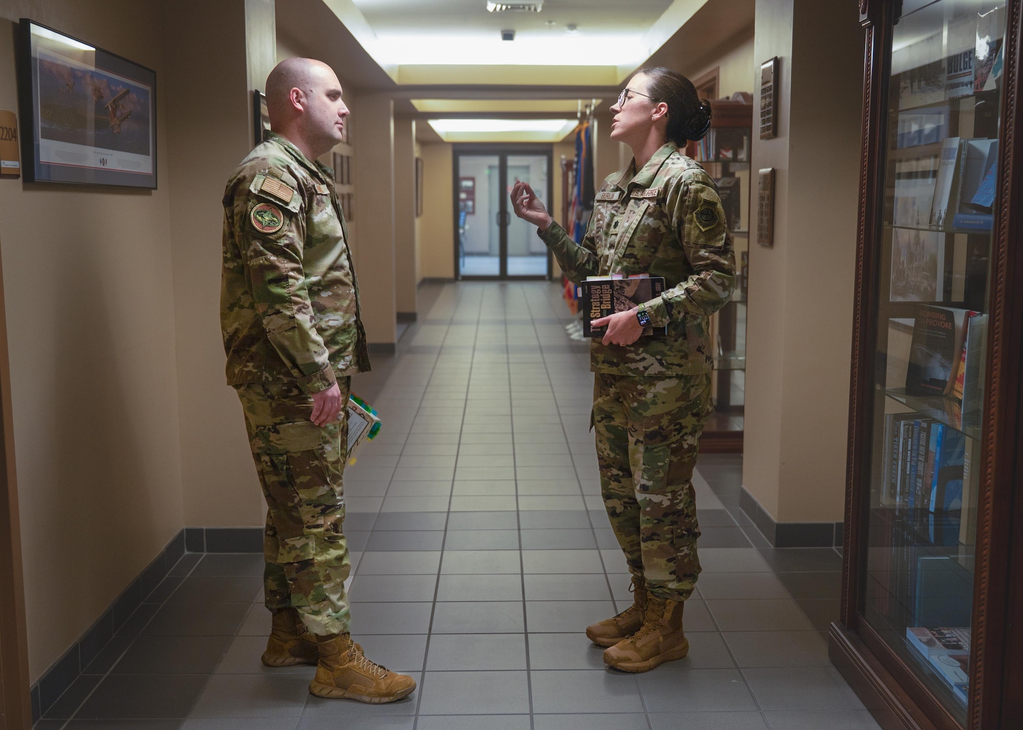 U.S. Air Force Lt. Col. Cameron Berlin and Maj. Daniel Hayes, School of Advance Air and Space Studies students, debate class topics about ethics in war at Maxwell Air Force Base, Alabama. March 2, 2026.