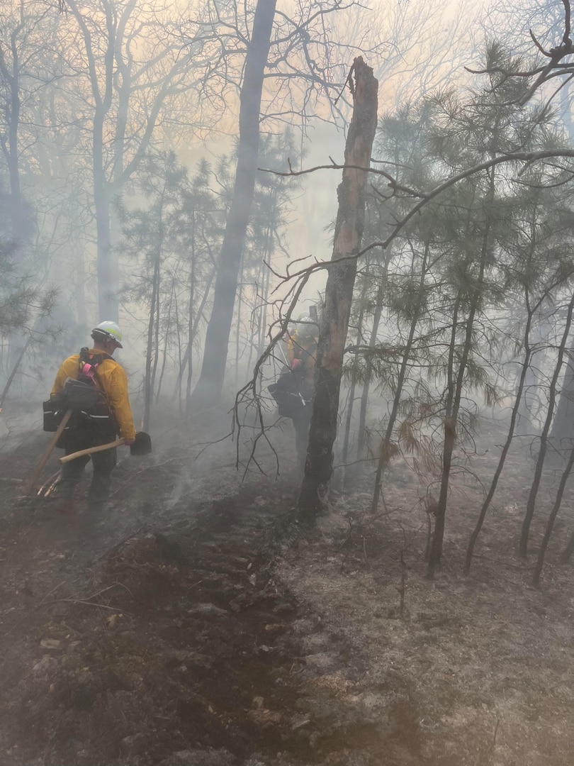 Oklahoma National Guard wildland firefighters partrol a fireline searching for hotspots during fire fighting operations near Talihinia, Oklahoma, Feb. 27, 2026. Two eight-Guardsmen crews have been deployed to support the Oklahoma Department of Emergency Management, Oklahoma Department of Agriculture, Oklahoma Department of Public Safety and Oklahoma Forestry Services battle wild fires in the state. The Oklahoma National Guard Wildland Firefighting Program has more than 80 red-card certified Guardsmen trained to support federal, state and local agencies in combating fires. (photo provided by OKNG Wildland Firefighting Program)