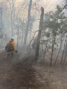 Oklahoma National Guard wildland firefighters partrol a fireline searching for hotspots during fire fighting operations near Talihinia, Oklahoma, Feb. 27, 2026. Two eight-Guardsmen crews have been deployed to support the Oklahoma Department of Emergency Management, Oklahoma Department of Agriculture, Oklahoma Department of Public Safety and Oklahoma Forestry Services battle wild fires in the state. The Oklahoma National Guard Wildland Firefighting Program has more than 80 red-card certified Guardsmen trained to support federal, state and local agencies in combating fires. (photo provided by OKNG Wildland Firefighting Program)