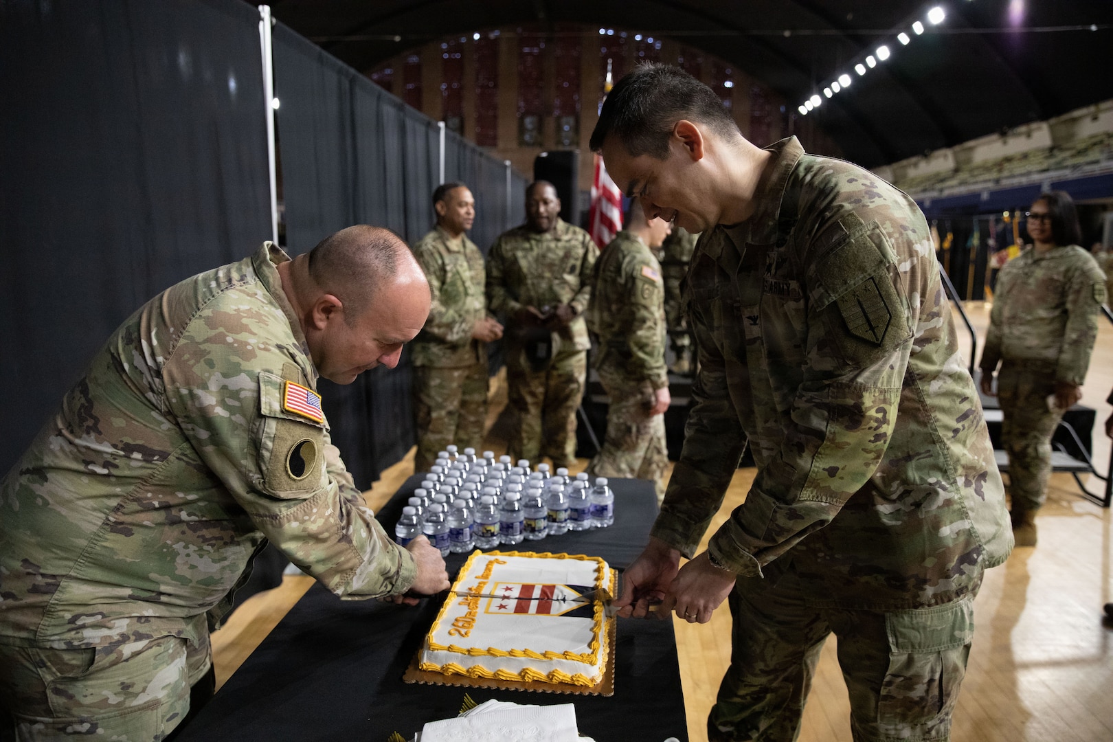 U.S. Army Col. Larry Doane, commander of the 260th Special Purpose Brigade (right), and Command Sgt. Maj. Larry Mckennon, senior enlisted leader (left), cut a celebratory cake after the 260th Special Purpose Brigade activation ceremony at the D.C. Armory, in Washington, D.C., March 7, 2026.