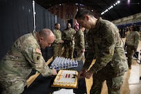 U.S. Army Col. Larry Doane, commander of the 260th Special Purpose Brigade (right), and Command Sgt. Maj. Larry Mckennon, senior enlisted leader (left), cut a celebratory cake after the 260th Special Purpose Brigade activation ceremony at the D.C. Armory, in Washington, D.C., March 7, 2026.