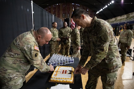U.S. Army Col. Larry Doane, commander of the 260th Special Purpose Brigade (right), and Command Sgt. Maj. Larry Mckennon, senior enlisted leader (left), cut a celebratory cake after the 260th Special Purpose Brigade activation ceremony at the D.C. Armory, in Washington, D.C., March 7, 2026.