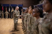 U.S. Army Lt. Col. Benjamin Brown with the D.C. National Guard, gives a Soldier a brigade unit patch during the 260th Special Purpose Brigade activation ceremony at the D.C. National Guard Armory in the District of Columbia on March 7, 2026. About 2,500 National Guard members are supporting the mission, providing critical assistance to the Metropolitan Police Department to help ensure the safety of residents, commuters and visitors throughout the District.