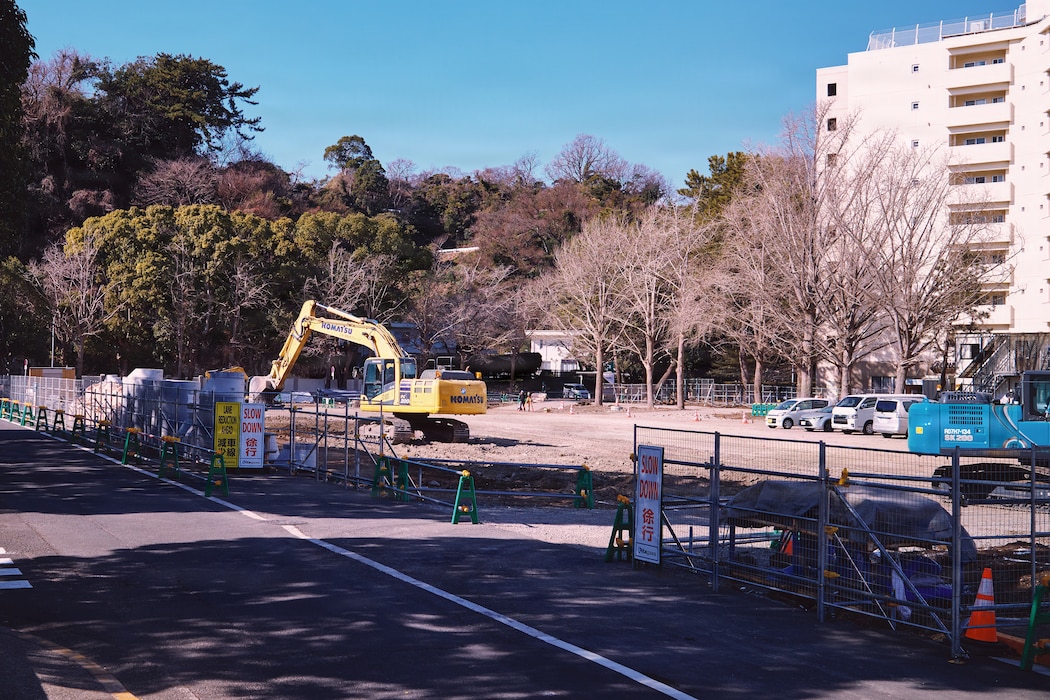 FLEET ACTIVITIES YOKOSUKA, Japan (January 30, 2026) -- Excavation work begins at the site of NA1807, a multi-level steel parking structure designed to provide approximately 460 privately-owned vehicles, January 30, 2026. The site was a underused parking lot serving Kyuban and Jyuban Unaccompanied Housing Towers. The improvements are estimated to be complete by the end of 2027. (U.S. Navy photo by James Kimber)