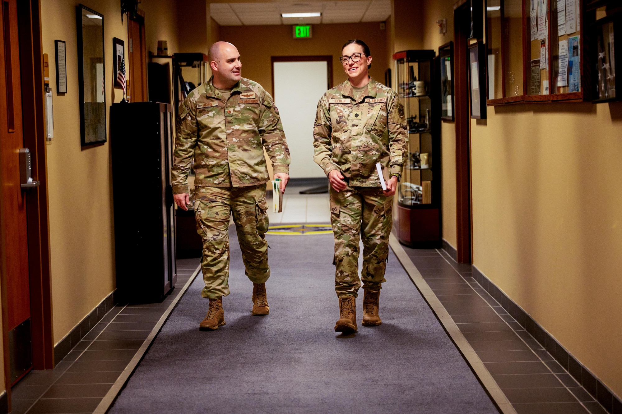 U.S. Air Force Maj. Daniel Hayes and Lt. Col. Cameron Berlin, School of Advance Air and Space Studies students, walk down a hall at Maxwell Air Force Base, Alabama, March 2, 2026.