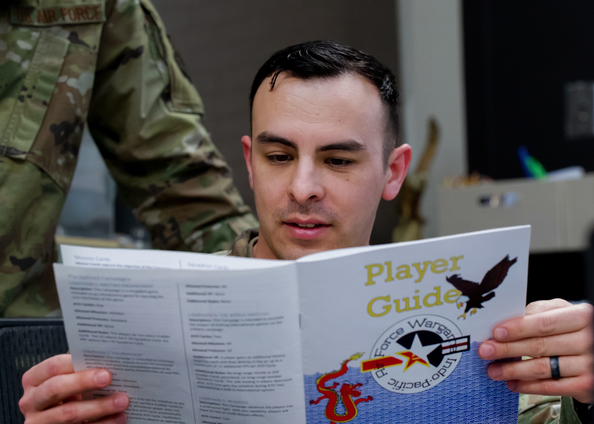 U.S. Air Force Master Sgt. Alfonzo Gonzalez, First Sergeant Academy student, reviews a wargaming player guide during a training session at Gunter Annex, Alabama, March 3, 2026.