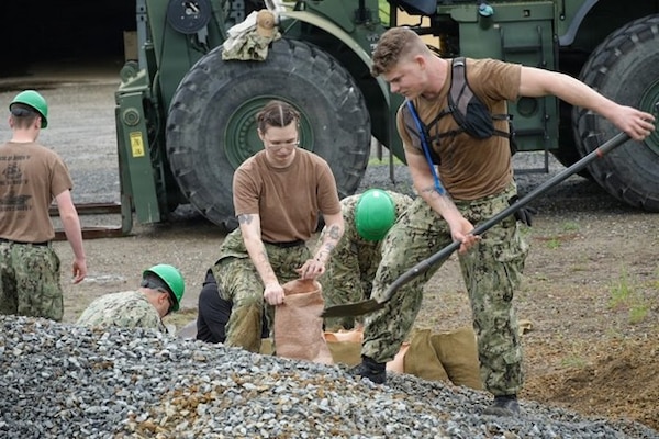 Hospital Corpsman 3rd Class Jacob Dempsey, general duty Corpsman, and Hospital Corpsman 2nd Class Alexis Roper, surgical technician, both assigned to Expeditionary Medical Facility (EMF) Kilo, Camp Lejeune, North Carolina, prepare sandbags during an EMF training at Naval Expeditionary Medicine Warfighter Development Center, Camp Pendleton, California, Feb. 9–18, 2026. Site preparation helps reinforce the facility and supports safe, sustained expeditionary medical operations. (U.S. Navy photo by Petty Officer 2nd Class Leandra Mojica)