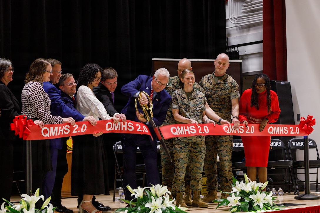 U.S. Marines and Ceremony Committee Members conduct the cutting of the ribbon during the grand opening of the Quantico Middle/High School on Marine Corps Base Quantico, Virginia, March 9, 2026. This event was held to dedicate the new Quantico Middle/High School building that was recently built, shining a light on a structure that will become a staple of MCB Quantico’s history. (U.S. Marine Corps photo by Lance Cpl. Lynsee Avila-Ramirez)