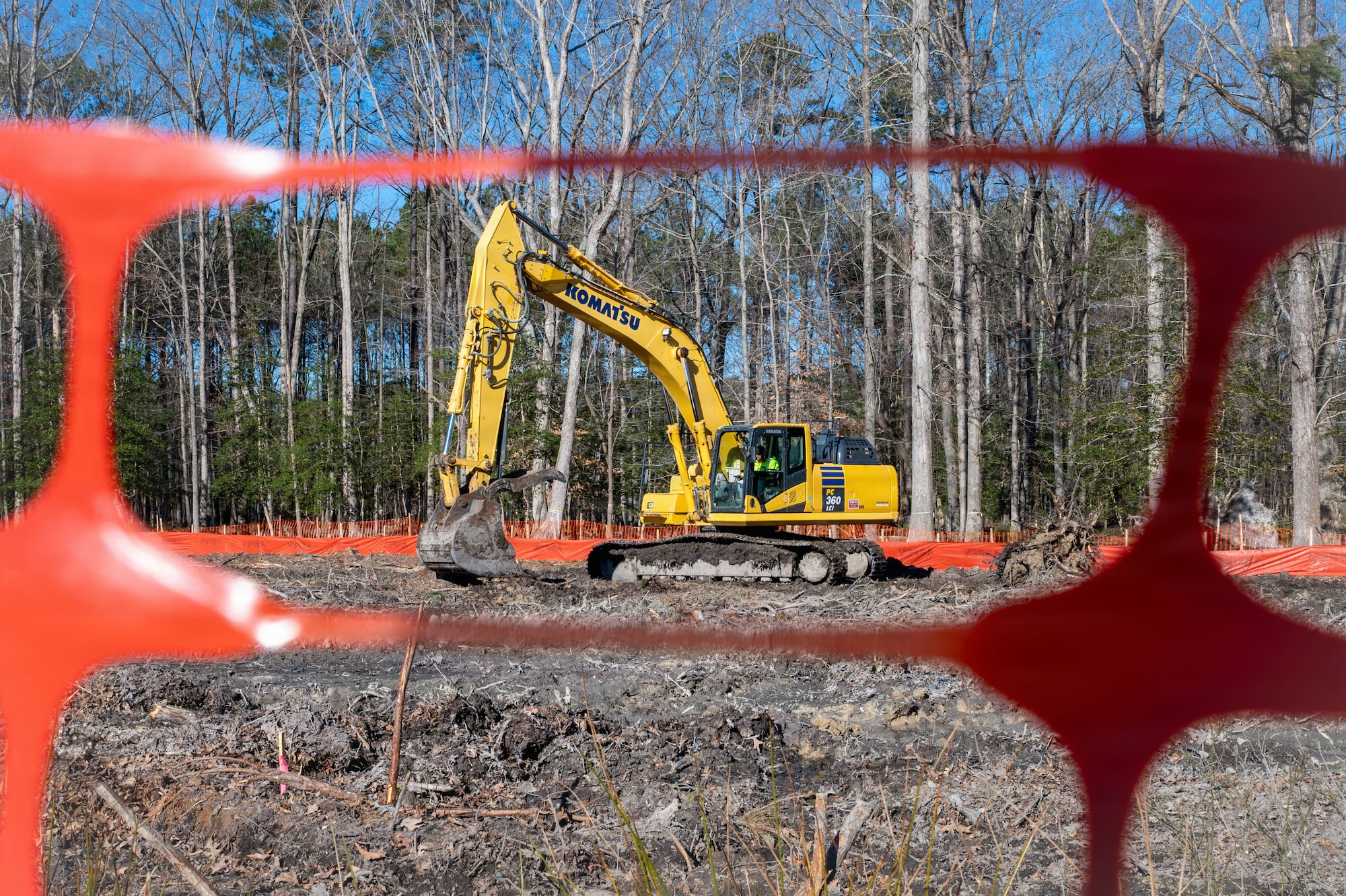 Photo showing heavy equipment sitting on a piece of land that it is clearing out.