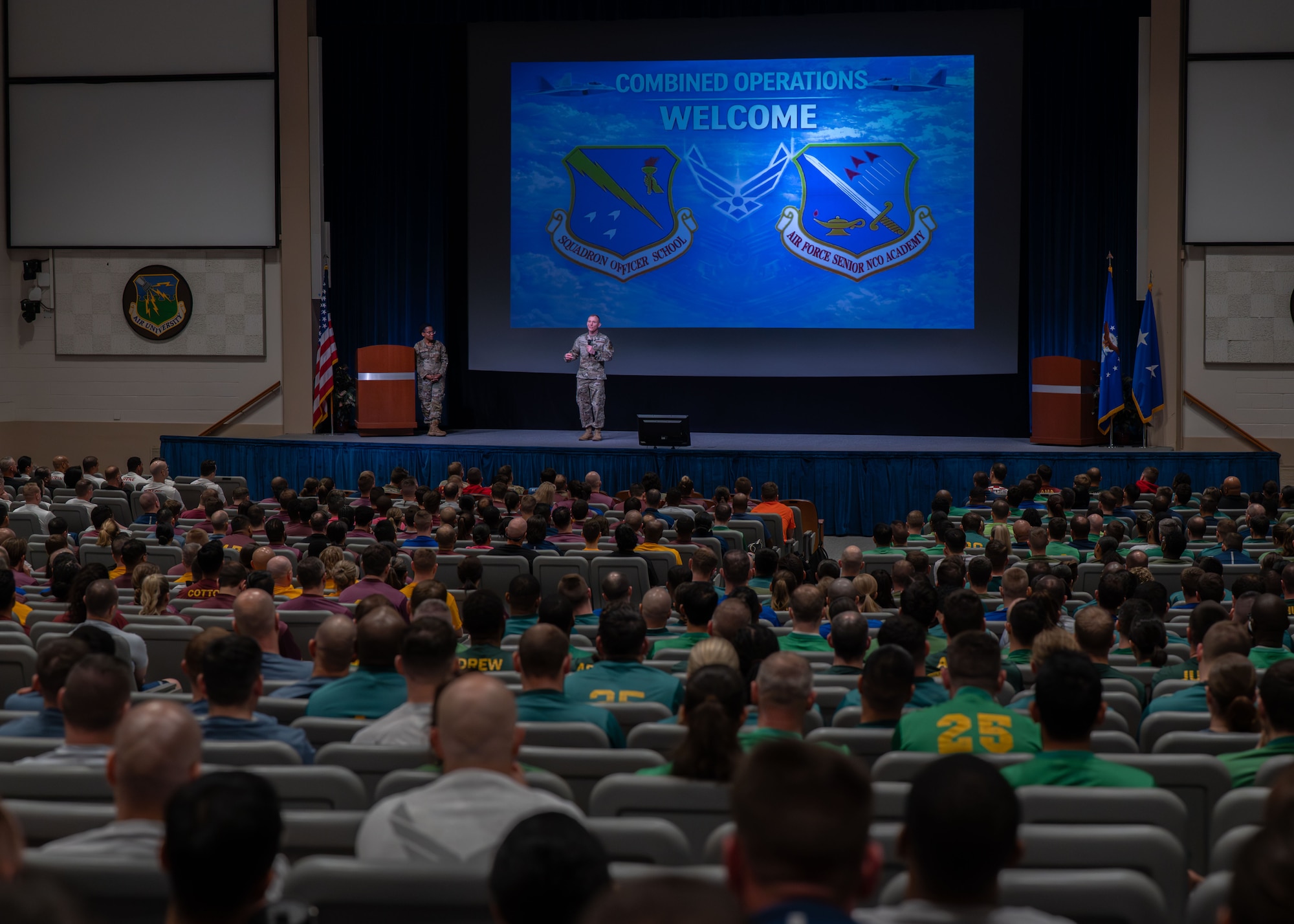 U.S. Air Force Chief Master Sgt. Joshua R. Tidwell, Senior Noncommissioned Officer Academy commandant and U.S. Air Force Col. Stephanie Q. Wilson, Thomas N. Barnes Center for Enlisted Education commander, address students from Squadron Officer School and the Senior Noncommissioned Officer Academy during a combined operations welcome at Maxwell Air Force Base, Alabama, March 5, 2026. (U.S. Air Force photo by Airman 1st Class Nelvis Sera)
