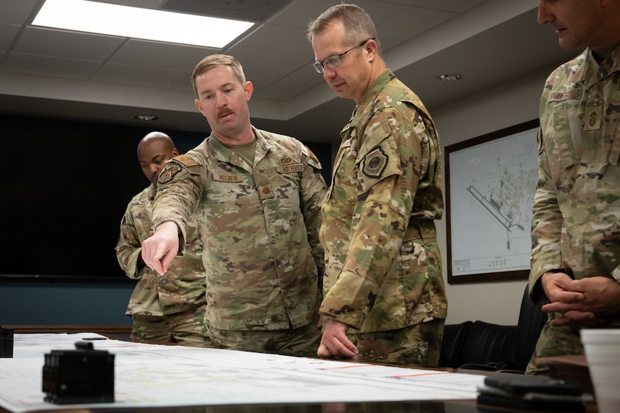 Maj. Dylan Bechen points to a part on a Civil Engineer map.
