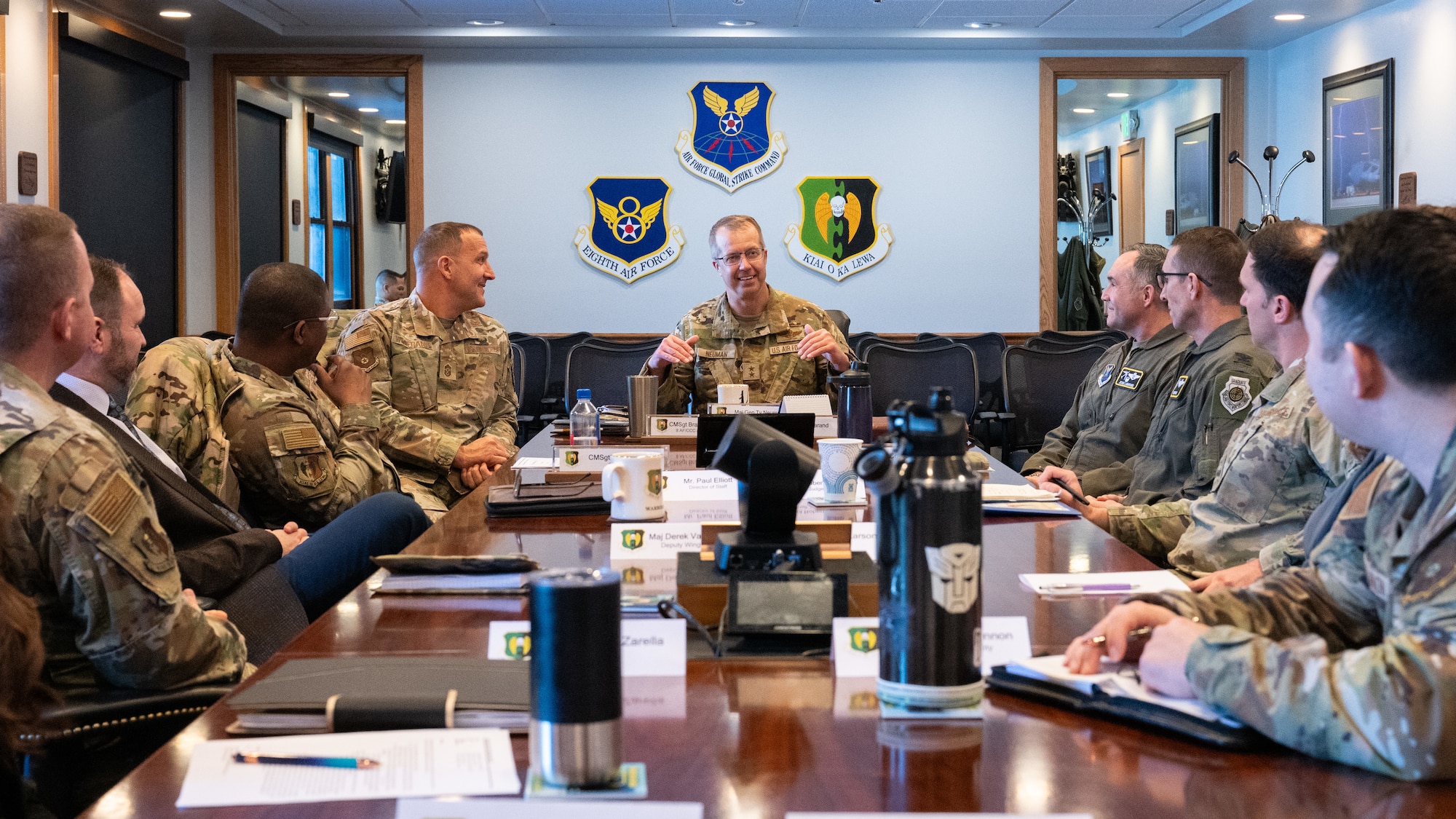 Airmen and civilian helping agency leads have a meeting together.