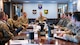 Airmen and civilian helping agency leads have a meeting together.