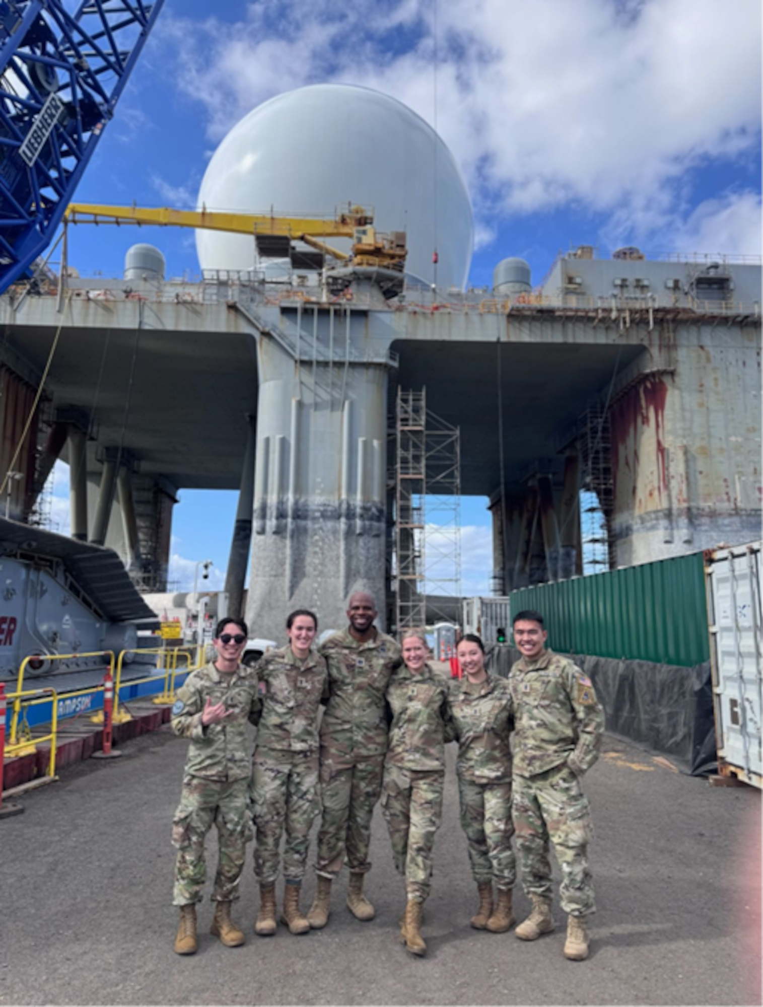 Members of SSC’s Galaxy cohort 13.5 (left to right) Lt. Garrison Lagapa, Lt. Coco (Julia) Kuchins, Capt. Gerald Hills, Lt. Emily Rowley, Lt. Amy Kang, Lt. Kevin Chang, join in front of the only Sea Based X-Band Radar in operational use in Pearl Harbor, Hawaii in January 2026. This massive, maneuverable, floating radar is designed to detect and track ballistic missiles, discriminating warheads from decoys. Members conducted engagements in Hawaii to understand Indo-Pacific Combatant Command priorities and how space supports joint warfighters, including threat briefings with SPACEFOR-INDOPAC and discussions with USINDOPACOM senior leaders. (Photo by David Lee)