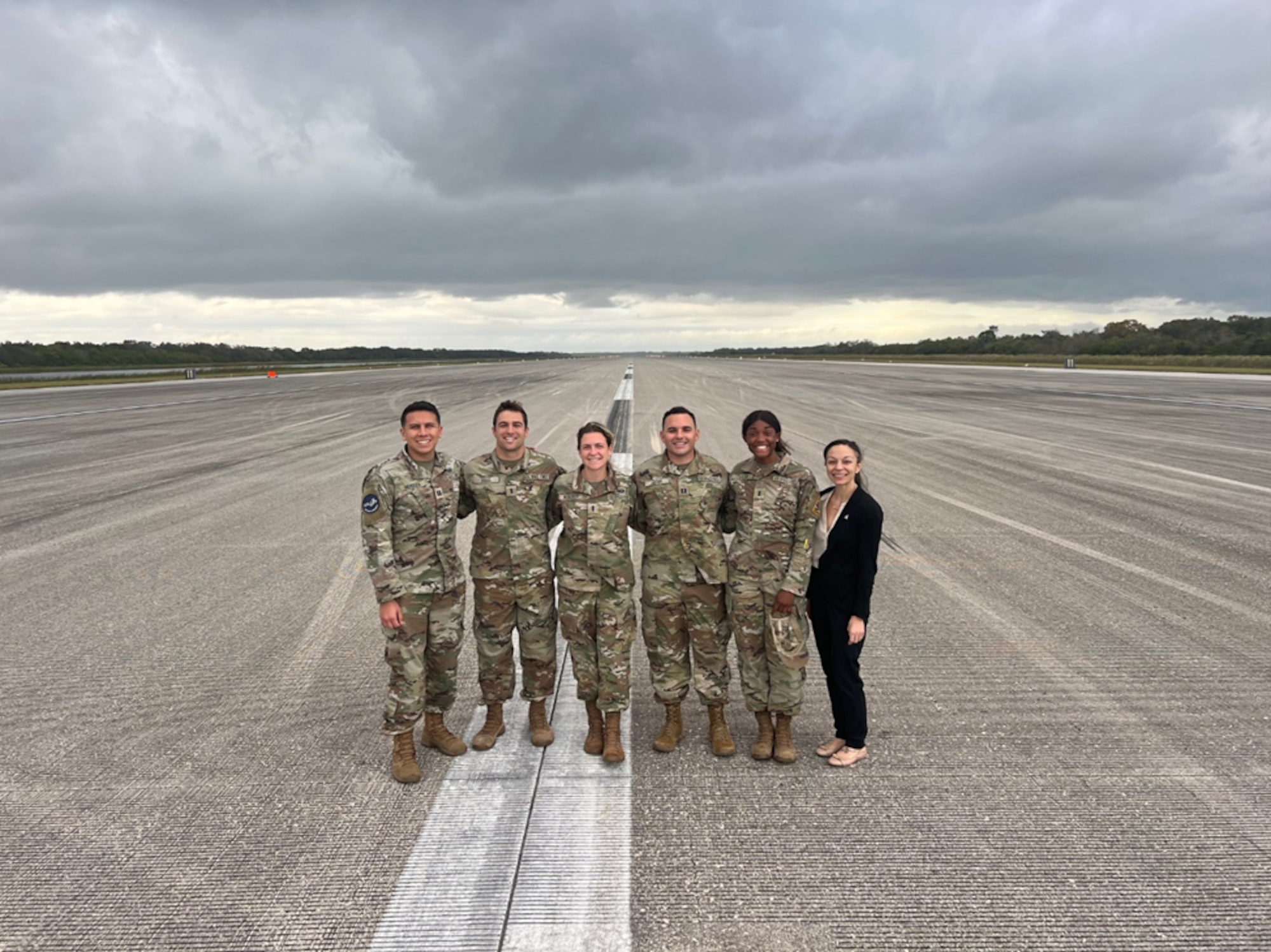 Galaxy cohort 12 members (left to right) Capt. Jake Mendoza, Capt. Greg Skage, 1st Lt Leigha Woelffer, Maj. Bryce Lieter (then Capt.), 1st Lt Sabrina Taylor, and Kristin Burk pose on Space Florida’s Launch and Landing Facility at Kennedy Space Center, Florida in 2024. During the six-month program, Galaxy Fellows visit critical USSF stakeholders and partners including intel, operations, Joint units, the Pentagon, Capitol Hill, Silicon Valley, and many other industry partners. (Courtesy photo from SSC Galaxy Program).