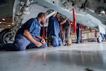 Aircraft maintainer assigned to the 12th Aircraft Maintenance Squadron, check the brake accumulator pressure and inspect the wheel well at Joint Base San Antonio-Randolph, Texas, Feb. 18, 2026. The inspection ensures the aircraft’s hydraulic and braking systems meet operational safety standards prior to flight. (U.S. Air Force photo by Zelideth Rodriguez)