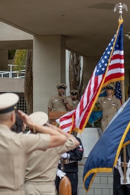 U.S. Navy Chief Petty Officer Carlton Tucker, senior enlisted leader at Navy Medicine Readiness and Training Unit North Island, sings the national anthem as Chief Petty Officer Joseph Vargas, Navy Medicine Readiness and Training Command San Diego command suite senior enlisted leader, and Command Master Chief Petty Officer Adolfo Gonzalez, outgoing NMRTC San Diego Command Master Chief, salute the flag during a change of charge ceremony at Naval Medical Center San Diego, March 9. NMRTC San Diego supports Navy and Marine Corps readiness by ensuring its medical forces are ready to deploy and provide medical support, ashore or at sea. (U.S. Navy photo by Mass Communication Specialist Seaman Jason Afable)