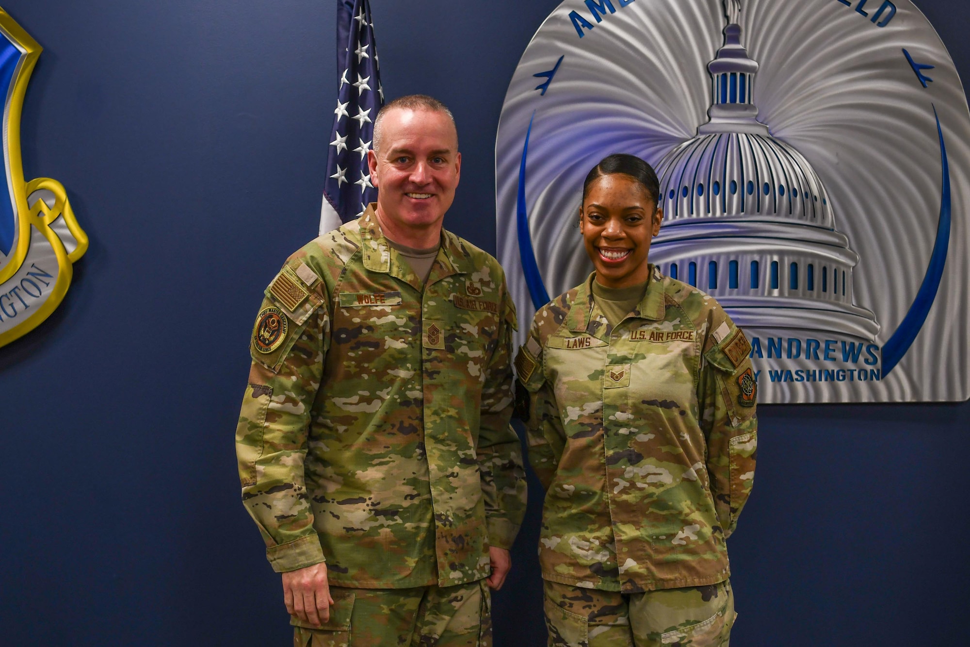 Airman speaks to crowd of troops.