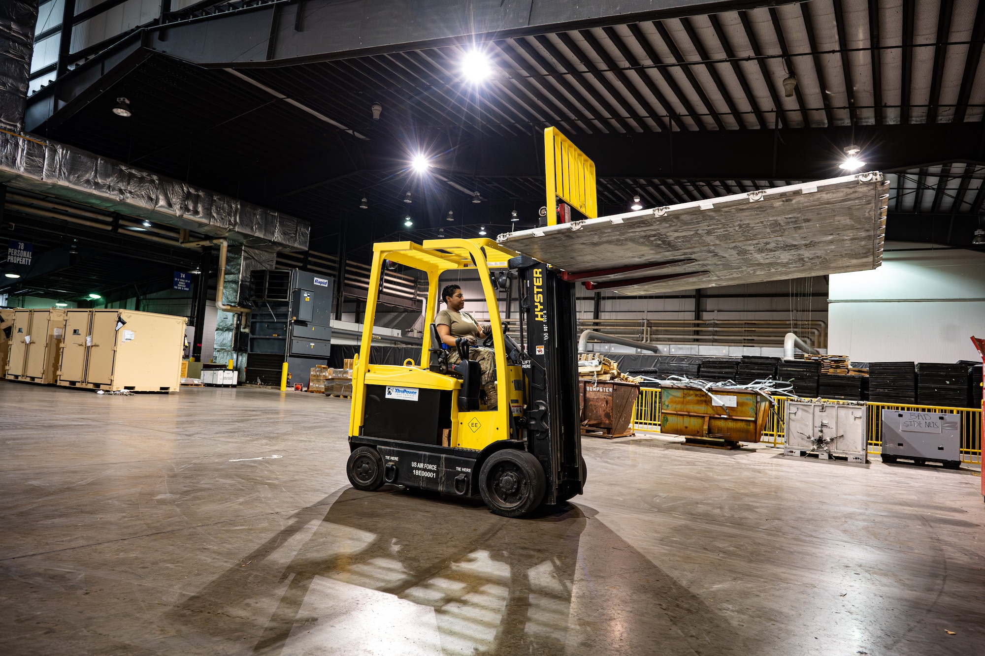 U.S. Air Force Airman 1st Class Natalya Garza, 436th Aerial Port Squadron cargo processor, operates a forklift inside the 436th Aerial Port on Dover Air Force Base, Delaware, Feb. 26, 2026. Cargo processors move and position cargo for pallet build-up and aircraft loading. (U.S. Air Force photo by Airman 1st Class Macy Dismore-Mann)