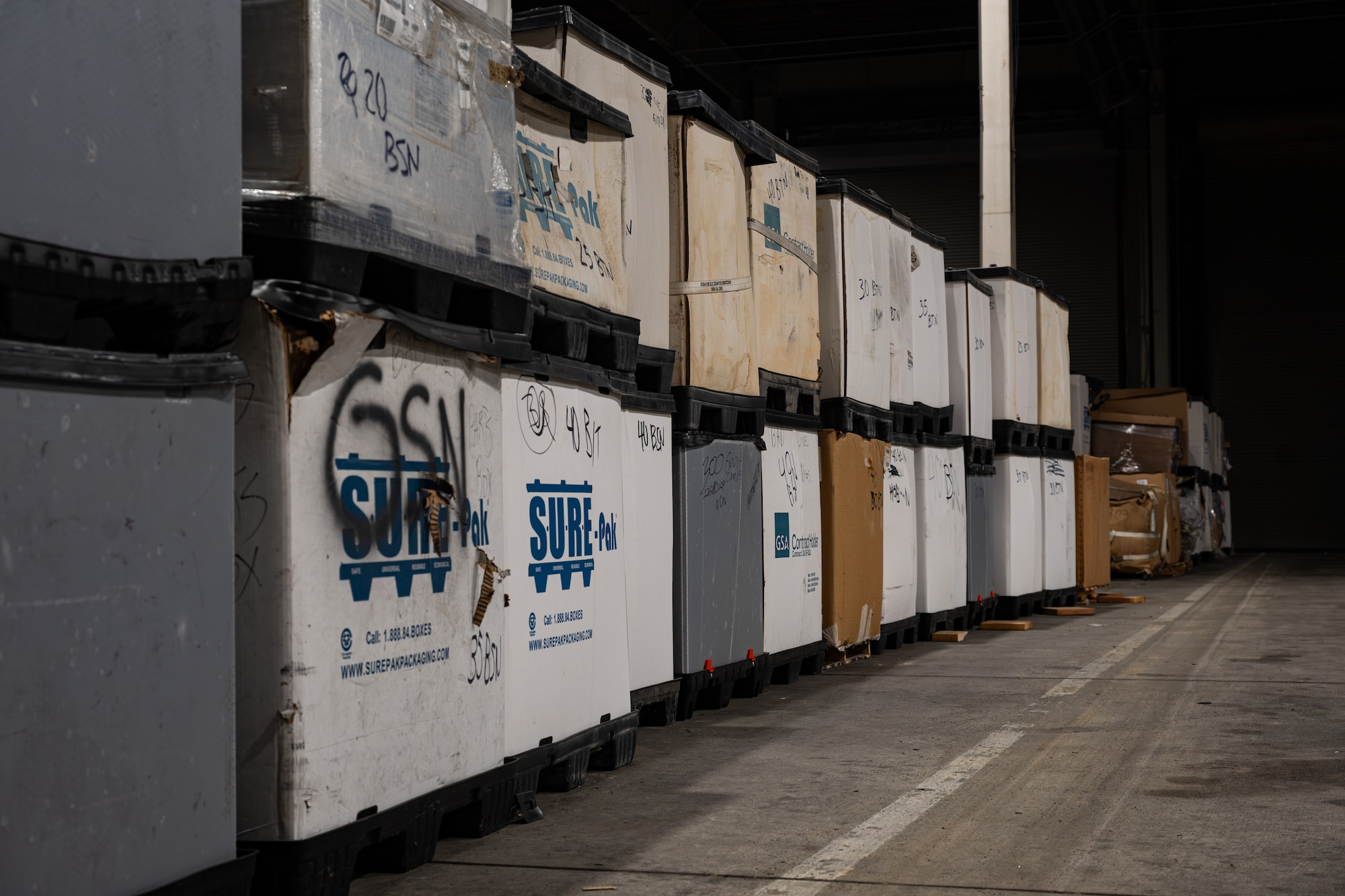 U.S. Air Force shipping containers are staged inside the warehouse at the 436th Aerial Port Squadron on Dover Air Force Base, Delaware, Feb. 26, 2026. APS Airmen process and prepare cargo for airlift missions, ensuring rapid global mobility support for Department of War operations worldwide. (U.S. Air Force photo by Airman 1st Class Macy Dismore-Mann)