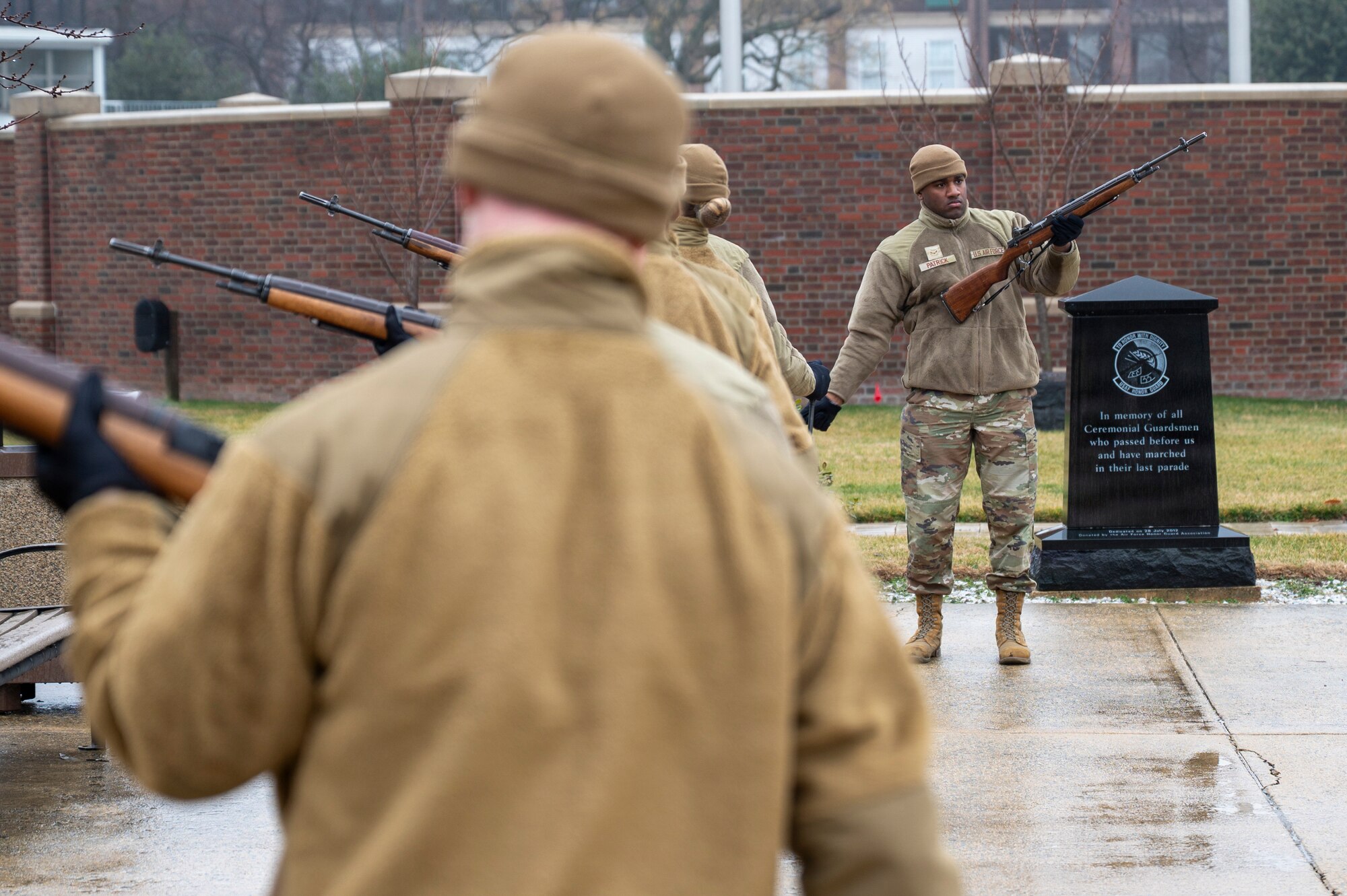 U.S. Air Force Airman 1st Class Terrance Patrick, right, a ceremonial guardsman with the U.S. Air Force Honor Guard Firing Party, demonstrates drill cadence and movement timing during training on Joint Base Anacostia-Bolling, Washington, D.C., March 3, 2026. The Firing Party trained on memorial honors, with one element of those honors the firing of three rifle volleys during funeral services at Arlington National Cemetery. (U.S. Air Force photo by Hayden Hallman)