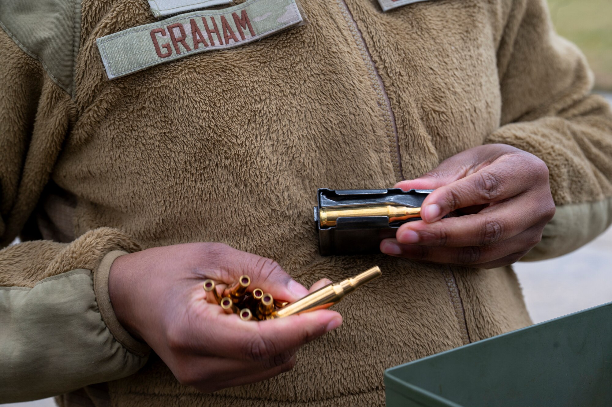 U.S. Air Force Senior Airman Dangela Graham, a ceremonial guardsman with the U.S. Air Force Honor Guard Firing Party, inserts blank rounds into an M14 rifle magazine prior to Firing Party training on Joint Base Anacostia-Bolling, Washington, D.C., March 3, 2026. While assigned to the Honor Guard, Airmen in the Firing Party maintain a rigorous training schedule of two to six hours each day and support memorial operations at Arlington National Ceremony. (U.S. Air Force photo by Hayden Hallman)