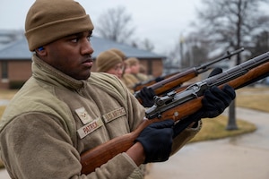U.S. Air Force Airman 1st Class Terrance Patrick, a ceremonial guardsman with the U.S. Air Force Honor Guard Firing Party, fires a three-round volley during training on Joint Base Anacostia-Bolling, Washington, D.C., March 3, 2026. Historically, three volleys of rifle fire indicated that casualties had been cared for in a combat environment and that the fighting could resume. These volleys became an official military custom that survives to this day. (U.S. Air Force photo by Hayden Hallman)